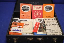 A CASE CONTAINING A COLLECTION OF CAR HAND BOOKS AND A QUANTITY OF NEWSPAPERS