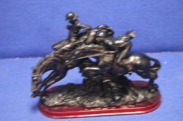 A CARVED RESIN FIGURE OF 2 HORSES AND RIDERS