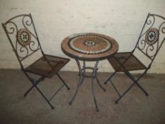 A TILED PATIO TABLE WITH 2 CHAIRS