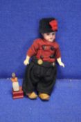 A SMALL ANTIQUE BISQUE HEADED DOLL TOGETHER WITH A SMALL WOODEN FIGURE A/F