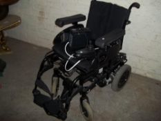 A POWERED WHEELCHAIR WITH CHARGER