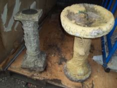A CONCRETE BIRD BATH AND A SUNDIAL