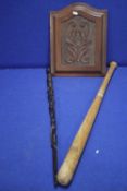 A CARVED WOODEN PANEL TOGETHER WITH A CARVED WALKING STICK AND A BASEBALL BAT