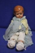 AN ANTIQUE PORCELAIN HEADED DOLL