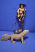 A CARVED IGUANA TOGETHER WITH A CARVED FIGURE OF A FISHERMAN