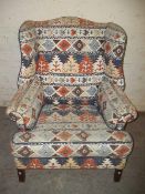 A WING BACK FIRESIDE CHAIR