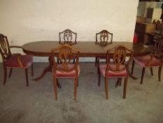 AN EXTENDING DINING TABLE AND 6 CHAIRS