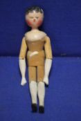 AN ANTIQUE CARVED WOODEN DOLL
