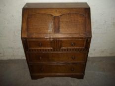 AN OAK BUREAU WITH LEATHER INLAY