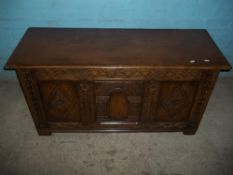 A SOLID OAK PANNELLED COFFER