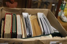 A BOX OF ASSORTED STAMPS IN ALBUMS