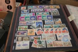 A BOX OF ASSORTED STAMPS IN ALBUMS