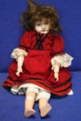 AN ANTIQUE PORCELAIN HEADED DOLL