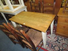 A MODERN DINING TABLE WITH FOUR CHAIRS