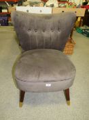 A MODERN UPHOLSTERED TAUPE CHAIR