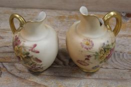 A ROYAL WORCESTER SMALL BLUSH IVORY JUG TOGETHER WITH ANOTHER - THE SECOND HAVING DAMAGES
