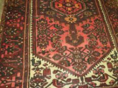 AN EASTERN WOOLLEN RUG 190 X 125 CM