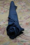 A ROLL OF DARK TEAL FABRIC