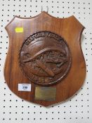 A CARVE WOODEN SHIELD SHAPED PLAQUE PRESENTED BY COMMANDING OFFICER OF USS GRAYBACK