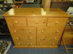 A MODERN HONEY PINE BANK OF NINE DRAWERS WITH A TOWEL RAIL AND MIRROR (3)