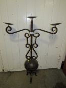 A LARGE WROUGHT IRON DECORATIVE THREE BRANCH CANDELABRA