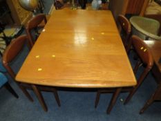 A MID CENTURY TEAK EXTENDING DINING TABLE AND FOUR CHAIRS