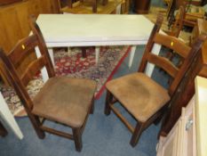 A MODERN DINING TABLE WITH TWO CHAIRS