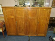 A LARGE OAK FOUR DOOR SCHOOL TYPE CUPBOARD H-136 W-194 CM NOTE -SPLITS IN TWO AND UNEVEN