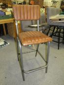 A TAN LEATHER BAR STOOL