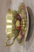 AN AYNSLEY AUTUMN FRUITS AND GILT CABINET CUP AND SAUCER