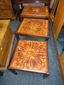 A MID CENTURY TILE TOP NEST OF TABLES