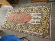 AN EASTERN WOOLLEN RUG 224 CM X 121 CM