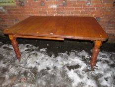 AN EDWARDIAN OAK WIND-OUT DINING TABLE WITH ONE SPARE LEAF