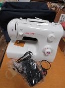 A SINGER TRADITION SEWING MACHINE WITH FABRIC CARRY CASE