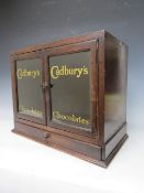 A LATE 19TH / EARLY 20TH CENTURY DISPLAY CABINET, with drawer to base and two glazed doors, the
