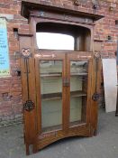 AN EARLY 20TH CENTURY ARTS AND CRAFTS CABINET, having typical copper stylised mounts to the front,