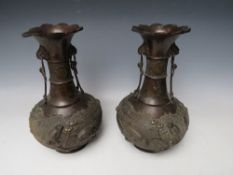 A PAIR OF LATE 19TH / EARLY 20TH CENTURY BRONZE ORIENTAL VASES, of baluster outline, each