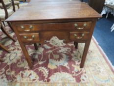 A 19TH CENTURY MAHOGANY LOW BOY, the two plank overhung top above a full length single drawer and