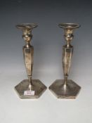 A PAIR OF HALLMARKED SILVER CANDLESTICKS BY HAWKSWORTH EYRE & CO LTD, with Staffordshire