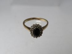 A HALLMARKED 9CT GOLD SAPPHIRE AND DIAMOND CLUSTER DRESS RING, ring size P, approximate weight 3.2