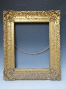 AN 18TH CENTURY DECORATIVE GOLD FRAME WITH CORNER EMBELLISHMENTS, frame W 10 cm, frame rebate 47 x