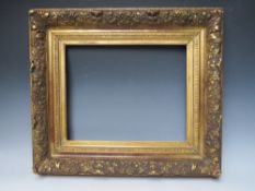 A LATE 18TH / EARLY 19TH CENTURY DECORATIVE GOLD FRAME, with leaf design to outer edge, frame W 11