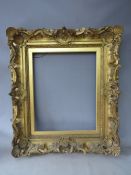 A 19TH CENTURY DECORATIVE GOLD SWEPT FRAME, with gold slip, frame W 10.5 cm, slip rebate 51 x 41 cm,
