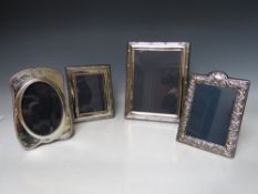 A COLLECTION OF FOUR HALLMARKED SILVER EASEL BACKED PHOTO FRAMES, varying sizes, dates