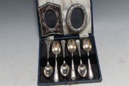 A CASED SET OF HALLMARKED SILVER TEASPOONS - SHEFFIELD 1931, together with two small modern photo