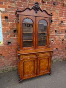 A 19TH CENTURY WALNUT GLAZED BOOKCASE, the upper section with twin glazed doors and carved moulded