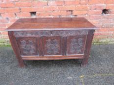 AN EARLY CARVED OAK THREE PANEL COFFER, raised on stile feet, H 62 cm, W 104 cm