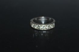 A HALLMARKED 18 CARAT WHITE GOLD SEVEN STONE DIAMOND ETERNITY RING, estimated total carat weight 1.