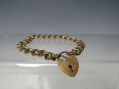 A HALLMARKED 9CT GOLD CHARM BRACELET, with hallmarked 9ct gold heart shaped clasp, approximately