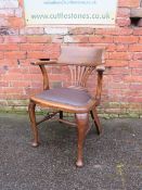 AN EARLY 20TH CENTURY OAK OFFICE ARMCHAIR, with upholstered seat, raised on cabriole supports